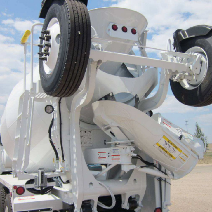 Rear view of a concrete mixer truck showcasing the drum, spare tire, and chute assembly for material discharge