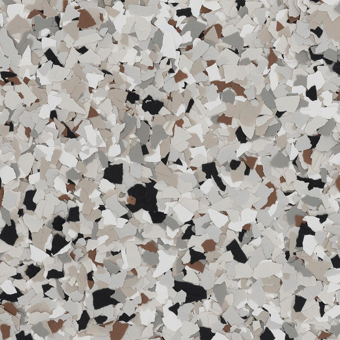 Coyote epoxy flake blend – top-down view showing 1/4" polymer flake mix of white, beige, gray, and black.